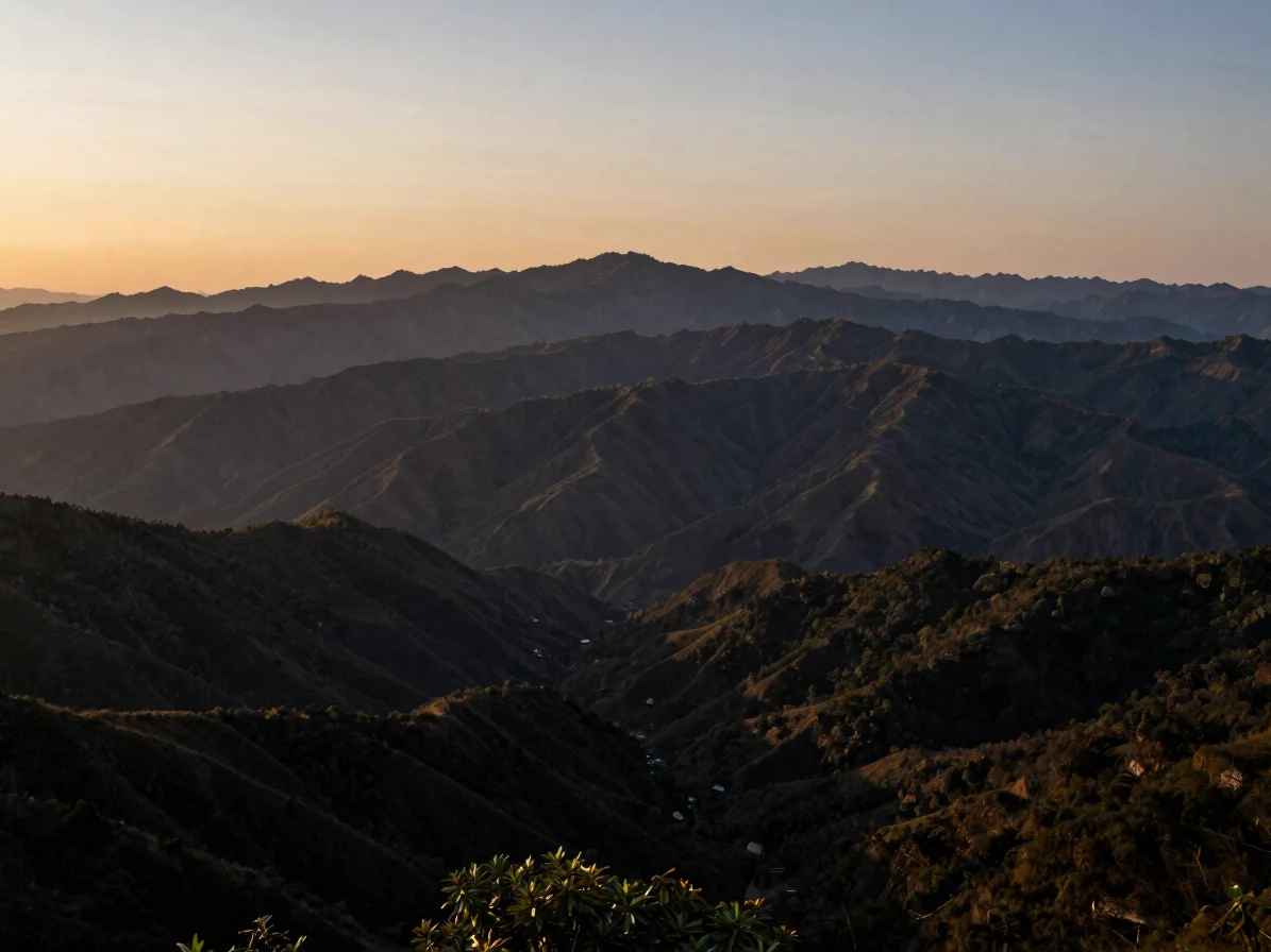 Expansive mountain range at twilight, soft dramatic light, 35mm w
