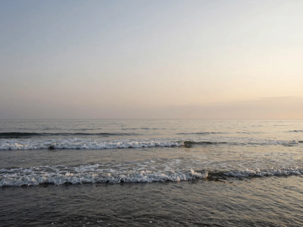 Calm coastal morning, soft overcast daylight, gentle waves, 35mm